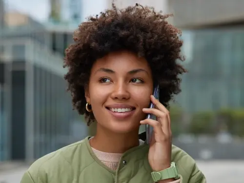 Smiling patient on phone call during Step 4 of dental treatment process.